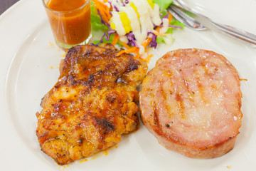 Chicken and ham steak combination with sauce