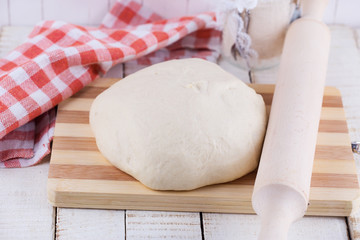 Dough on wooden board