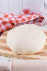 Dough on wooden board