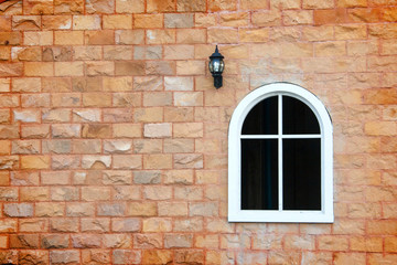 window and lamp on the brick wall