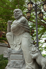 Kungfu master statue with lion.