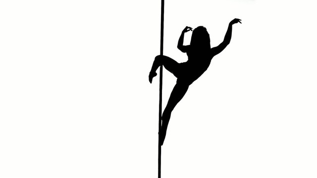 Silhouette of a sexy female pole dancing