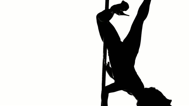 Silhouette of a sexy female pole dancing