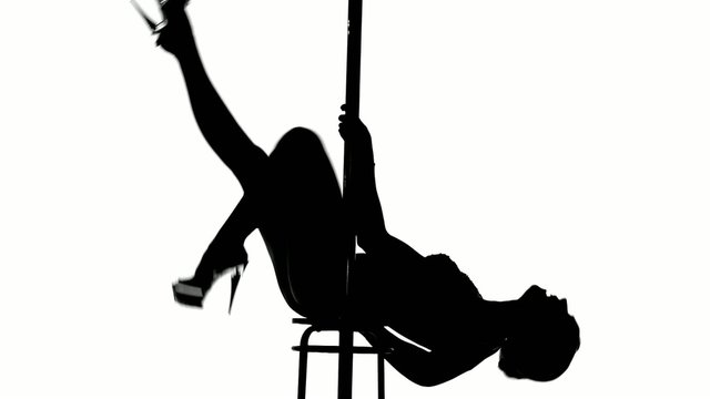 Silhouette of a sexy female pole dancing