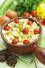 Zucchini baked with chicken, cherry tomatoes and herbs