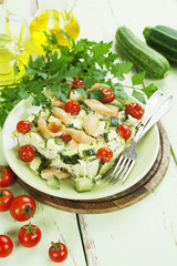 Zucchini baked with chicken, cherry tomatoes and herbs
