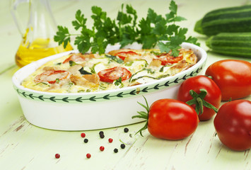 Zucchini baked with chicken, cherry tomatoes and herbs