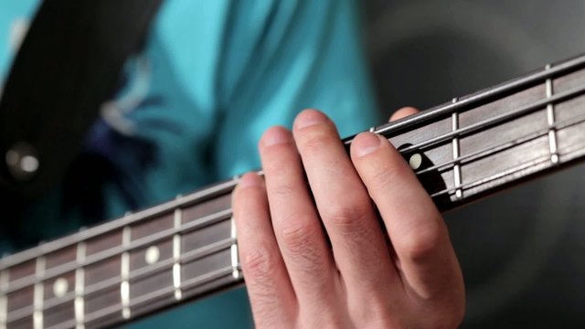 Men playing on bass close up footage