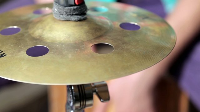 Cymbal in front of drummer playing at cajon