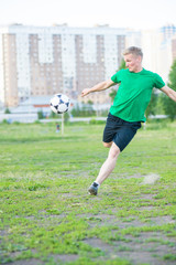 Soccer player strongly hits the ball.