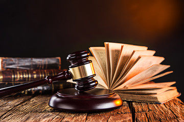 Wooden gavel and books on wooden table