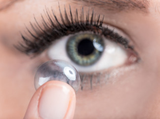 Woman inserting a contact lens