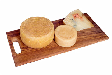 Dark wood board with assorted artisan cheese including blue.