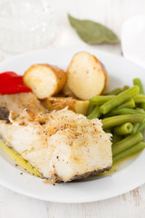fish with vegetables on white plate