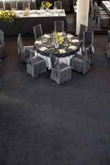 arranged round tables in the hall for weddings
