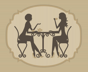 Silhouette of two beautiful girls talking in a cafe