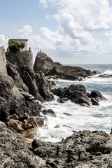 Fototapeta na wymiar Liguria Rocky Cliff on rough sea