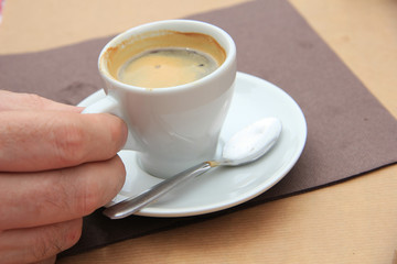 Man holding espresso cup