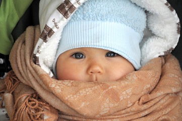 Baby in warm clothes in cold weather