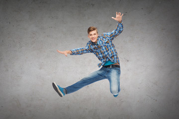 Obraz na płótnie Canvas smiling young man jumping in air