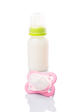 Baby pacifier and a bottle of baby formula milk