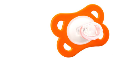 Orange colored pacifier over white background 