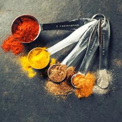 Colorful spices in metal spoons © Natalia Klenova