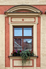 Fototapeta na wymiar Classical colorful window with pediment in Prague