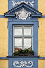 Classical colorful window with pediment in Prague