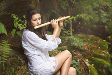 Beautiful woman playing  flute after the rain © captblack76