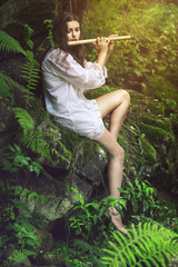 Beautiful dryad playing a flute © captblack76