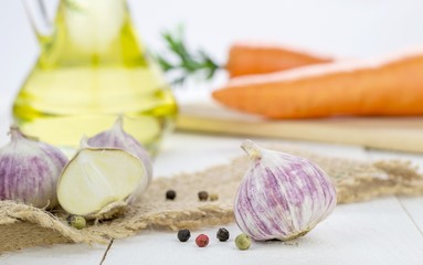 Garlic bulbs and cooking ingredients on kitchen table