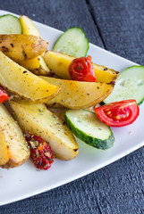 baked potato and raw vegetables on a white plate
