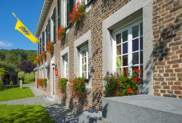 Ancient town hall with flag in sunlight