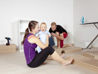 Obraz premium Young Family with a Baby Moving