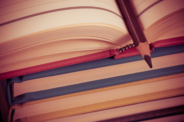 Close-up of open book and pen
