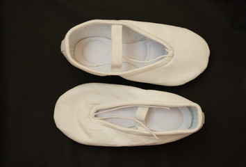 Ballet flats beige color on a dark background