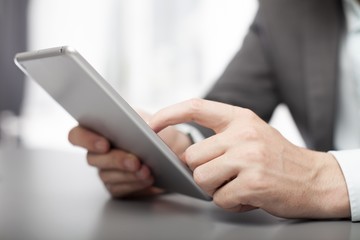 Businessman using his tablet in the office