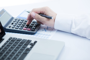 Businessman analyzing investment charts with laptop. Accounting