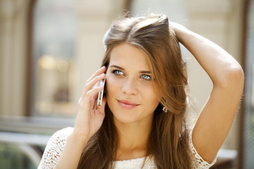 Fototapeta premium Portrait of a beautiful young woman calling by phone
