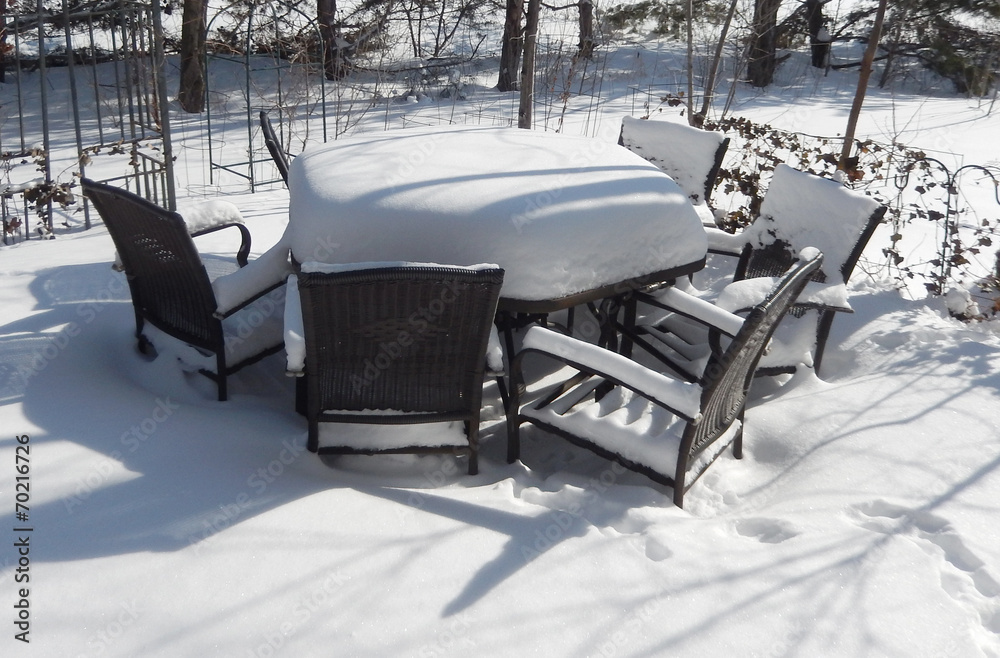 Wall mural Patio covered with snow on a bright winter day