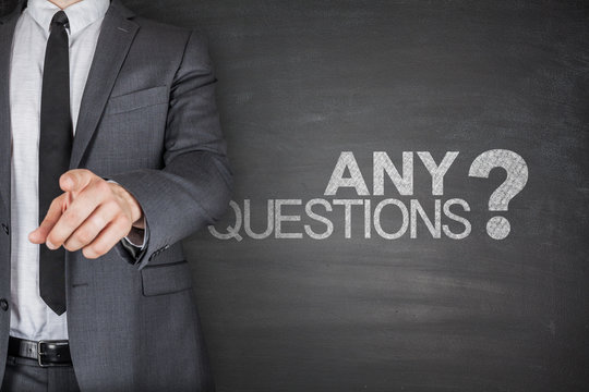 Any Questions concept on black Blackboard