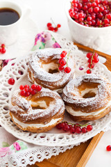 Cream puff rings decorated with fresh red currant