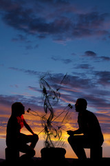Fototapeta na wymiar silhouette man and woman eating each others marshmallows