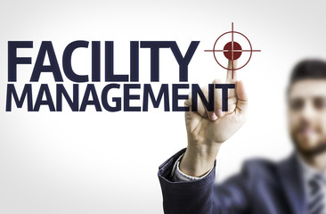Business man pointing the text: Facility Management