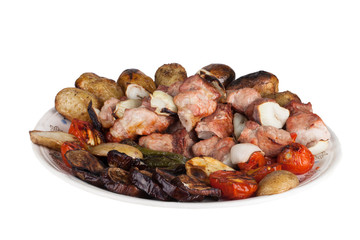 kebab and grilled vegetables on a plate isolated on white backgr