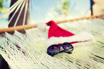 Fototapeta na wymiar hammock with santa helper hat and shades