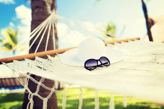 picture of hammock with white hat and sunglasses