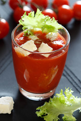 Glass of Tomato juice with feta and salad