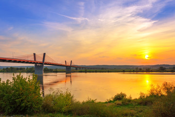 Cable stayed bridge over Vistula river in Poland at sunset.